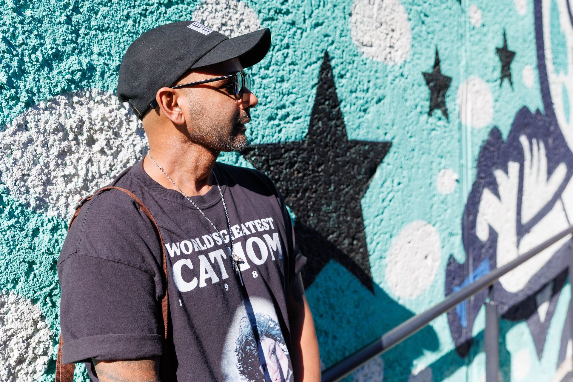 Amar in front of his mural